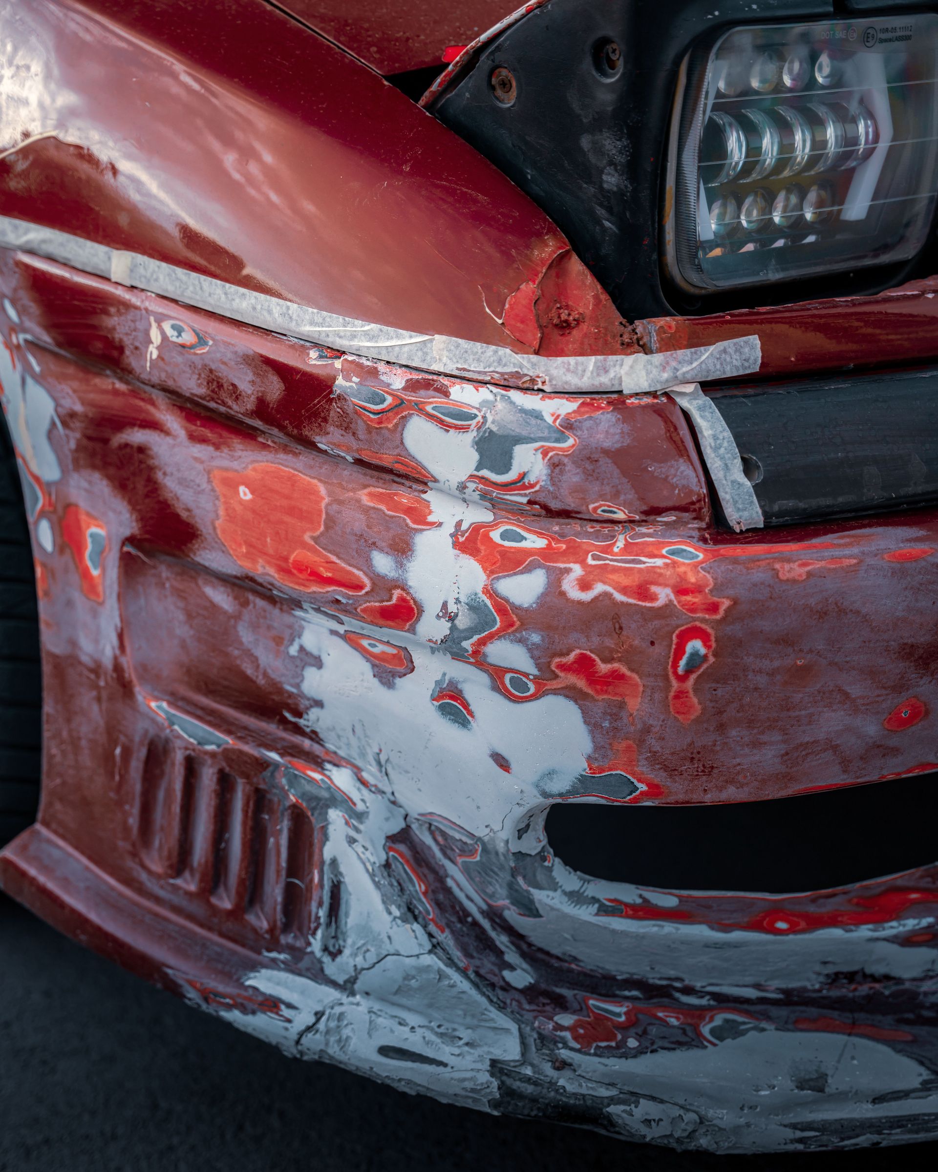 Close-up of a damaged vintage car in Ankara, showcasing weathered and worn paint details.